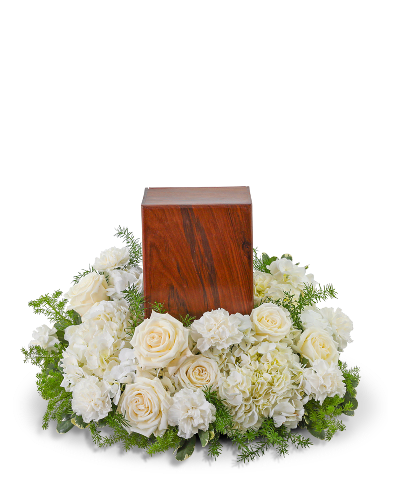 White roses and hydrangeas arranged around a wooden urn