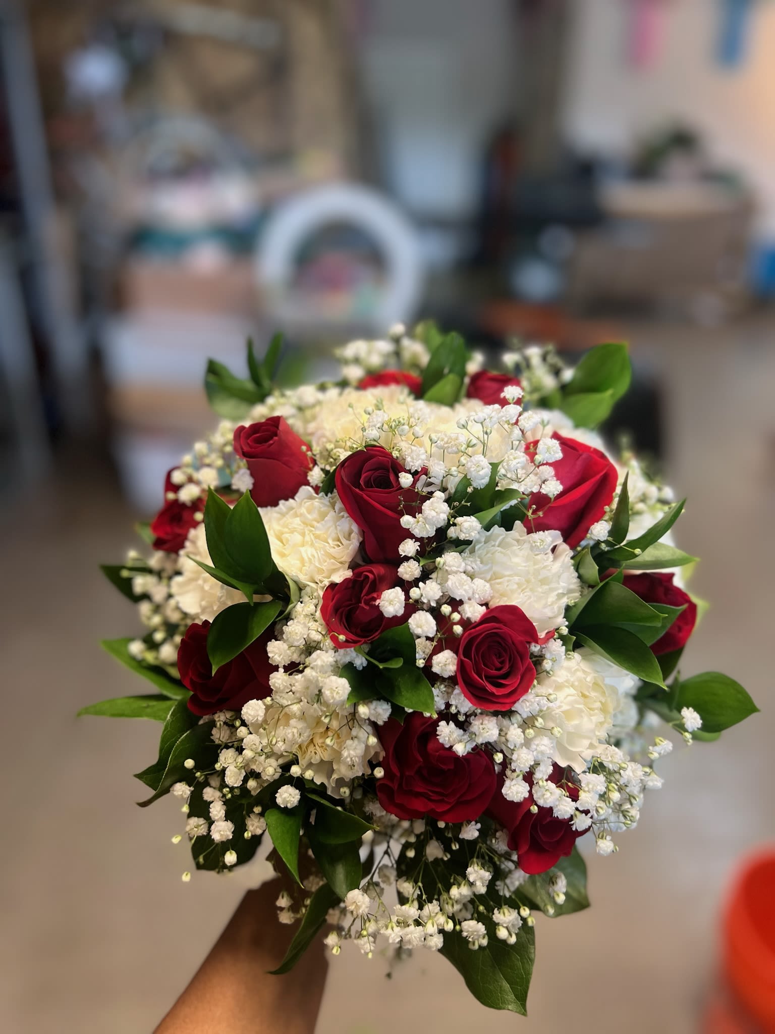 Bouquet of red roses and white carnations with baby's breath