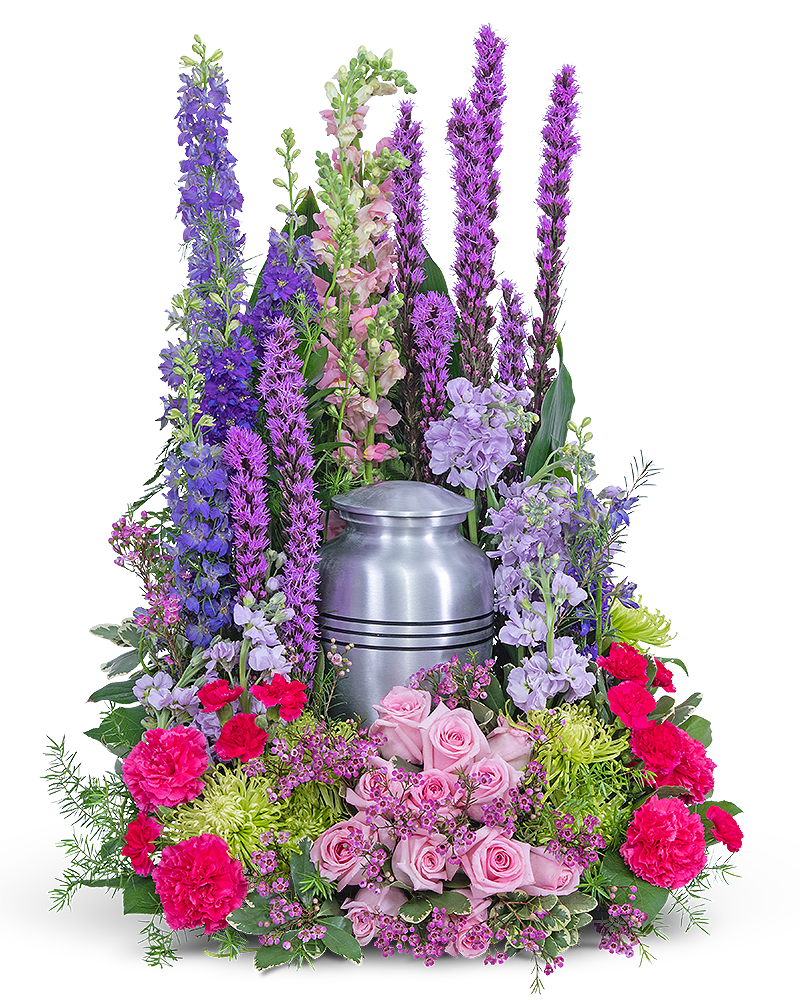 Tall floral arrangement around a silver urn with pink and purple flowers