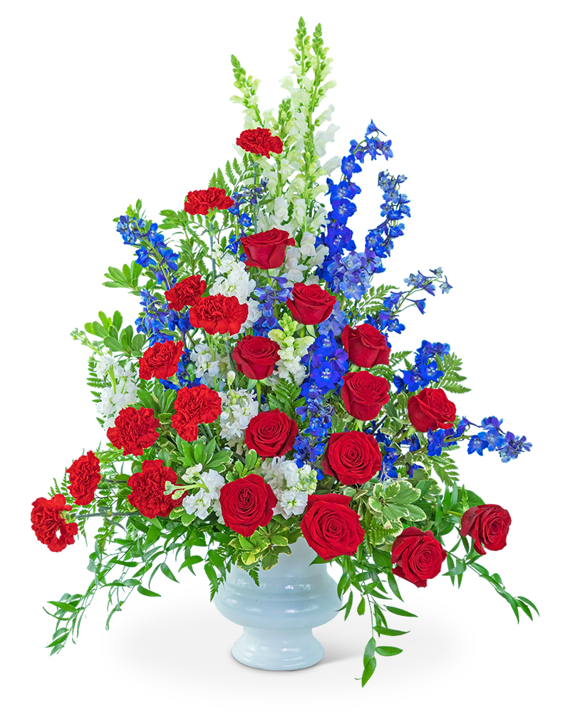 Red roses, red carnations, and blue flowers in a white vase
