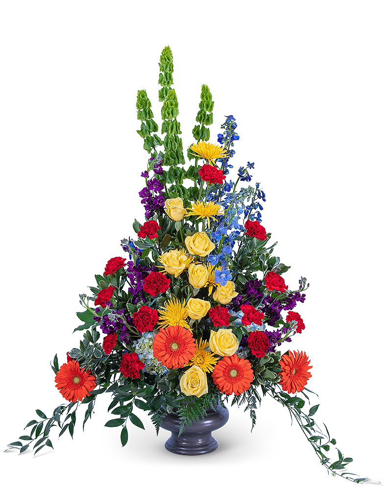 Tall mixed flower arrangement in a dark vase with orange gerberas and yellow roses