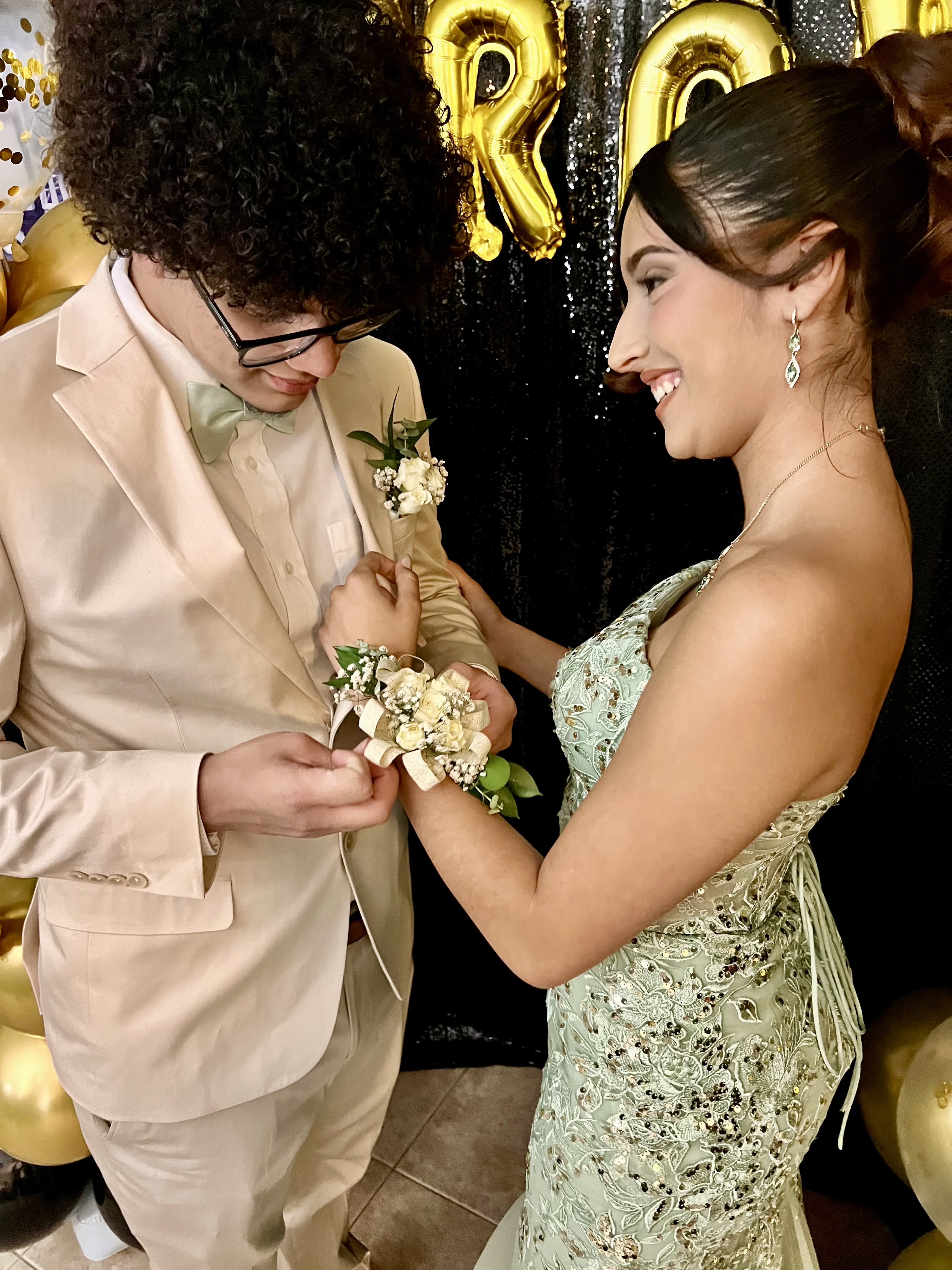 Young couple at a formal event with a boutonniere and corsage