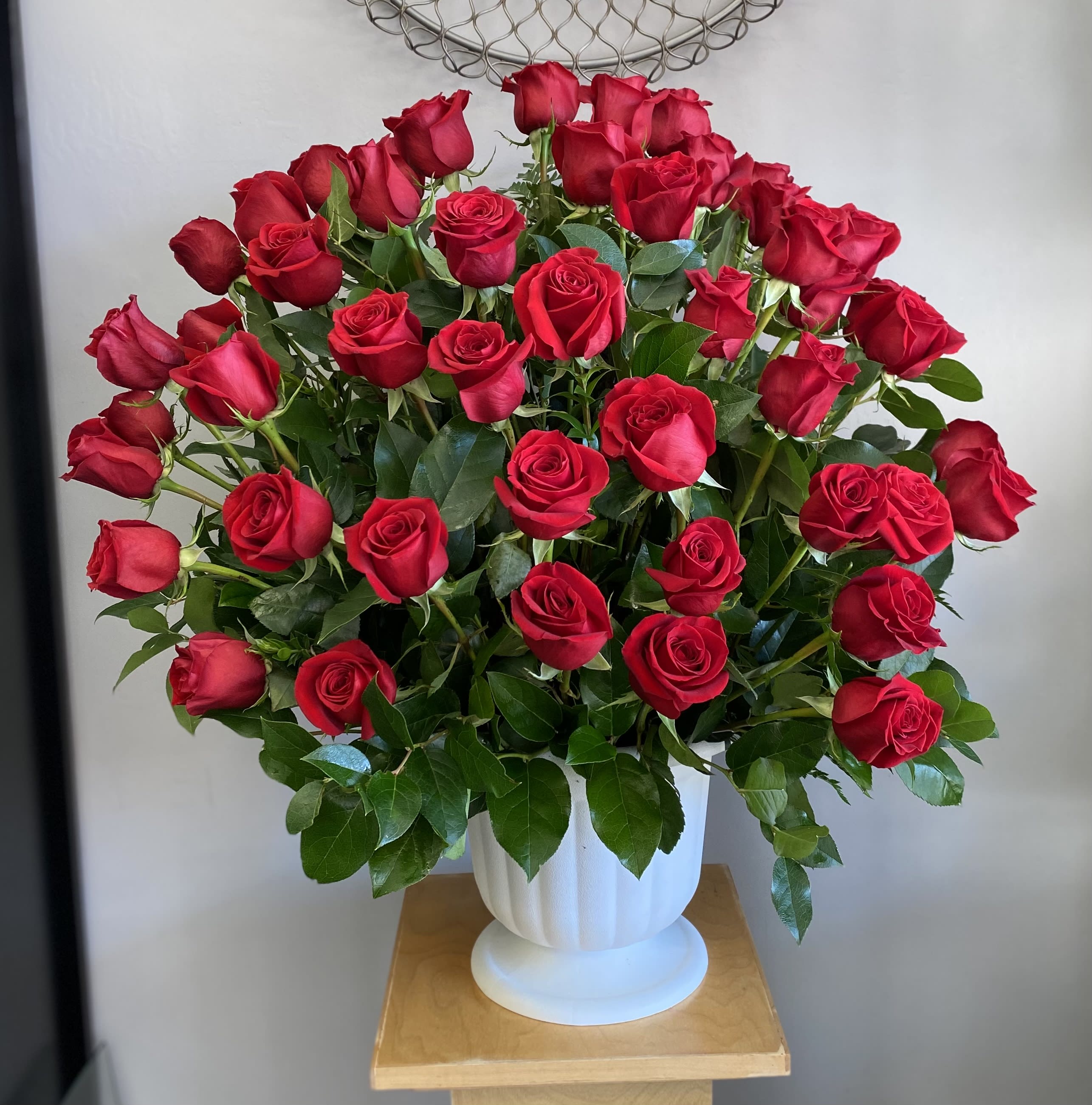 Bouquet of red roses in a white vase