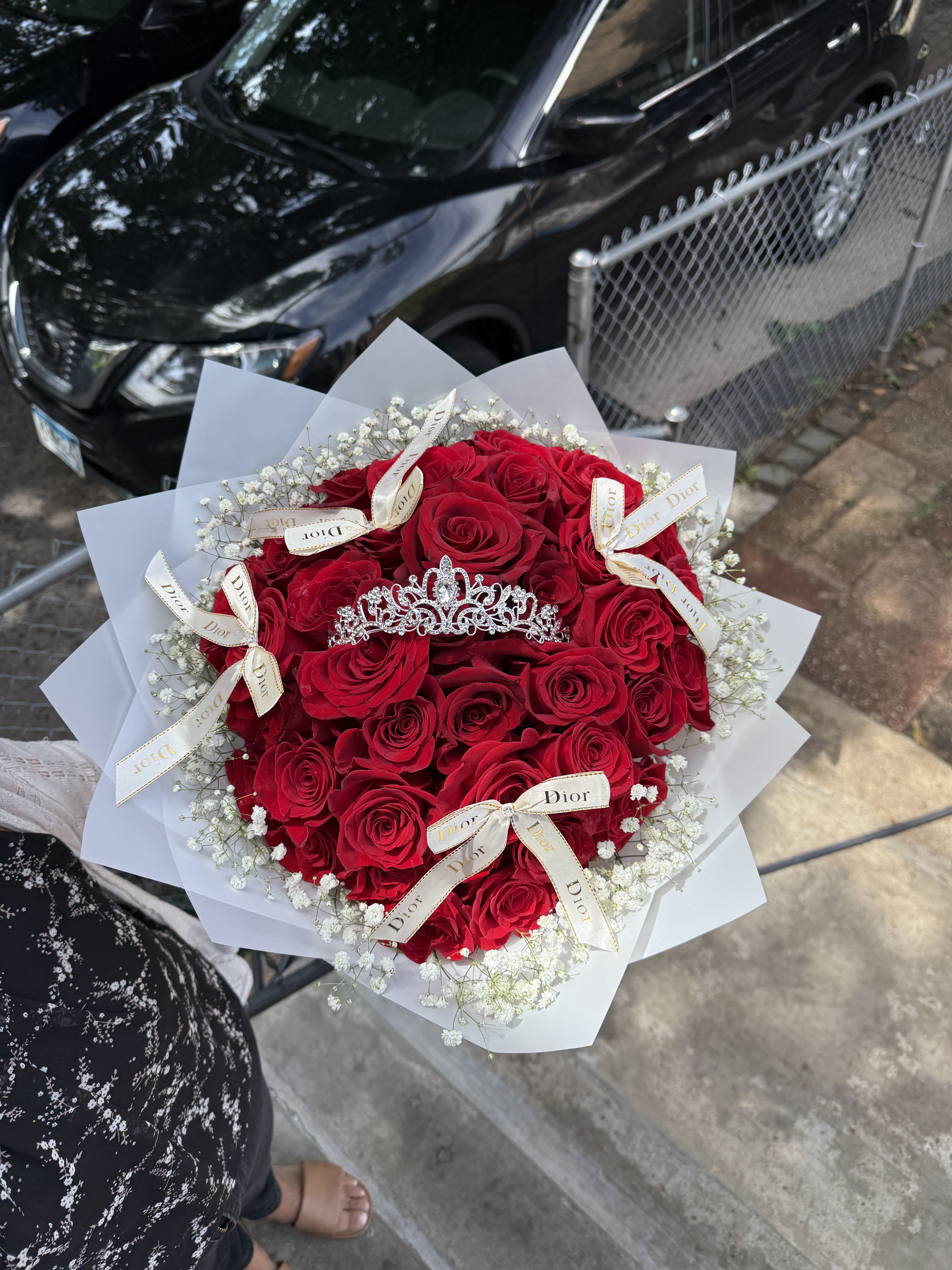 Bouquet of red roses with white baby's breath and a tiara topper