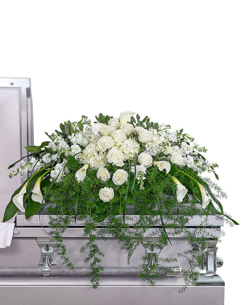 Large white floral casket spray with roses and calla lilies on a silver casket