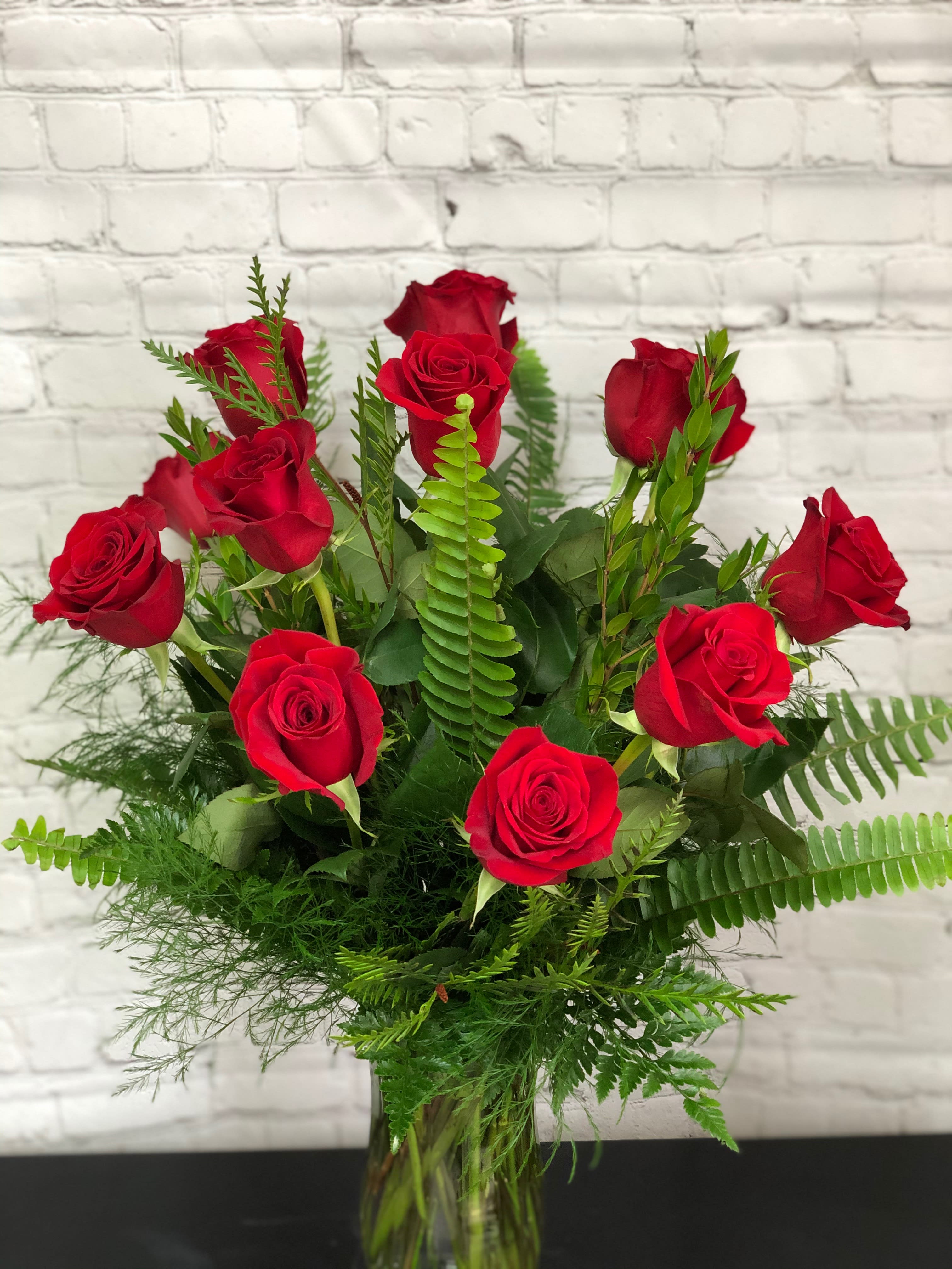Bouquet of red roses in a clear glass vase
