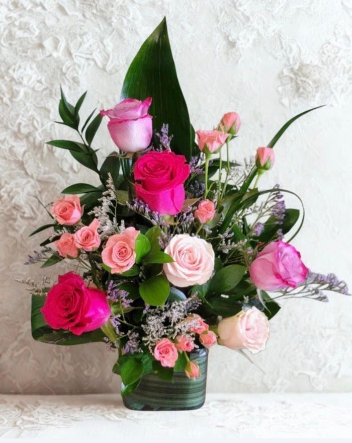 Sweet Elegance Mixed Flower - Show your love with this charming arrangement featuring six red roses  beautifully arranged and other mixed flowers in a modern square glass vase accented with lush greenery.