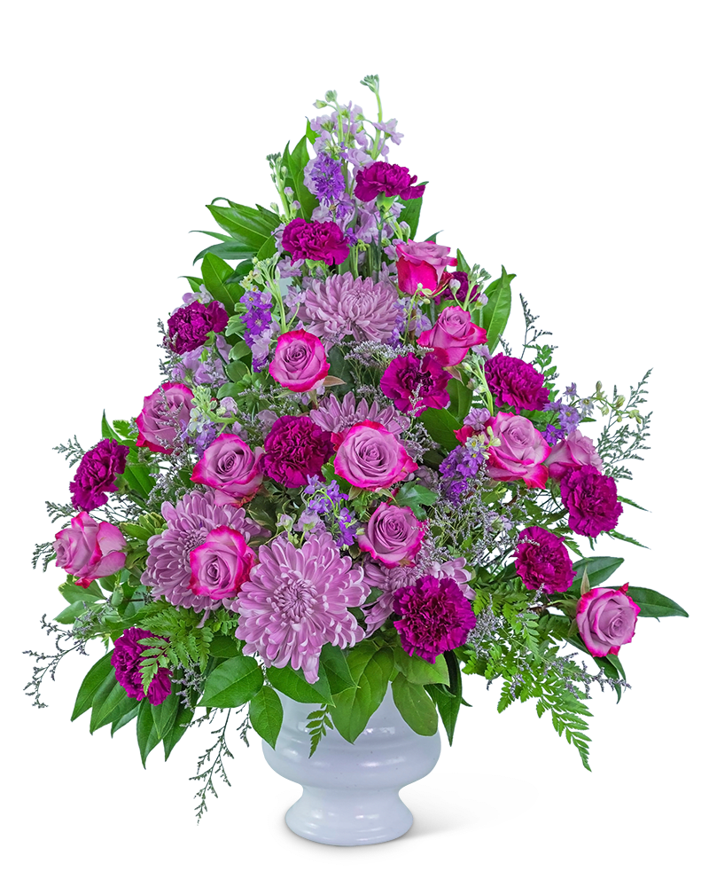 Pink and purple floral arrangement in a white vase