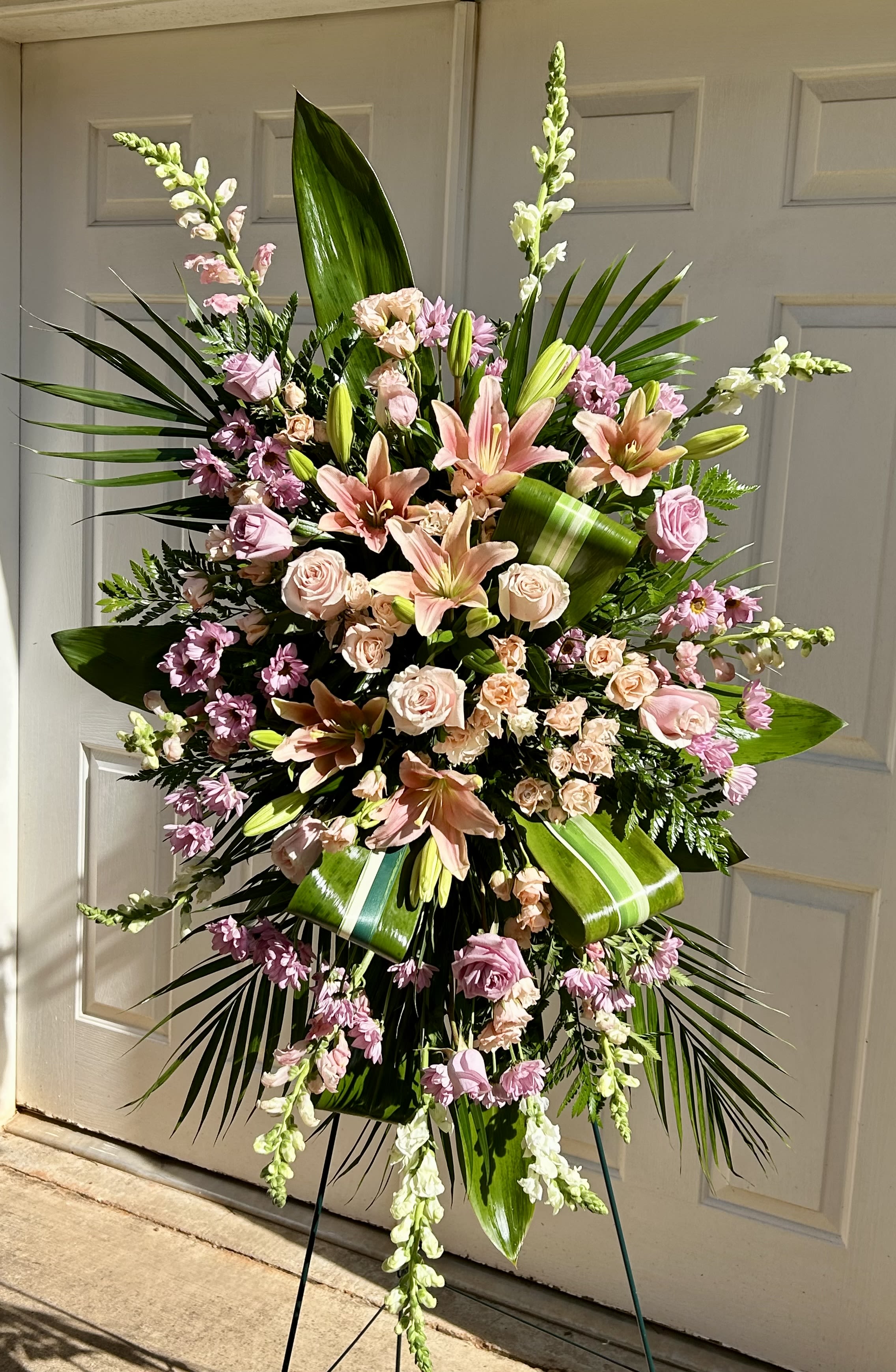 Large standing floral spray with pink lilies and roses