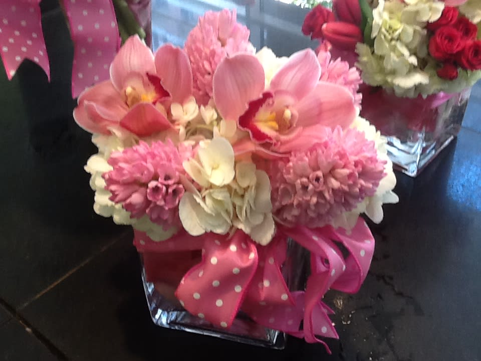Hello Spring - A sweet, feminine arrangement in a square. Hyacinth is out of the season. We will substitute with similar color flower.