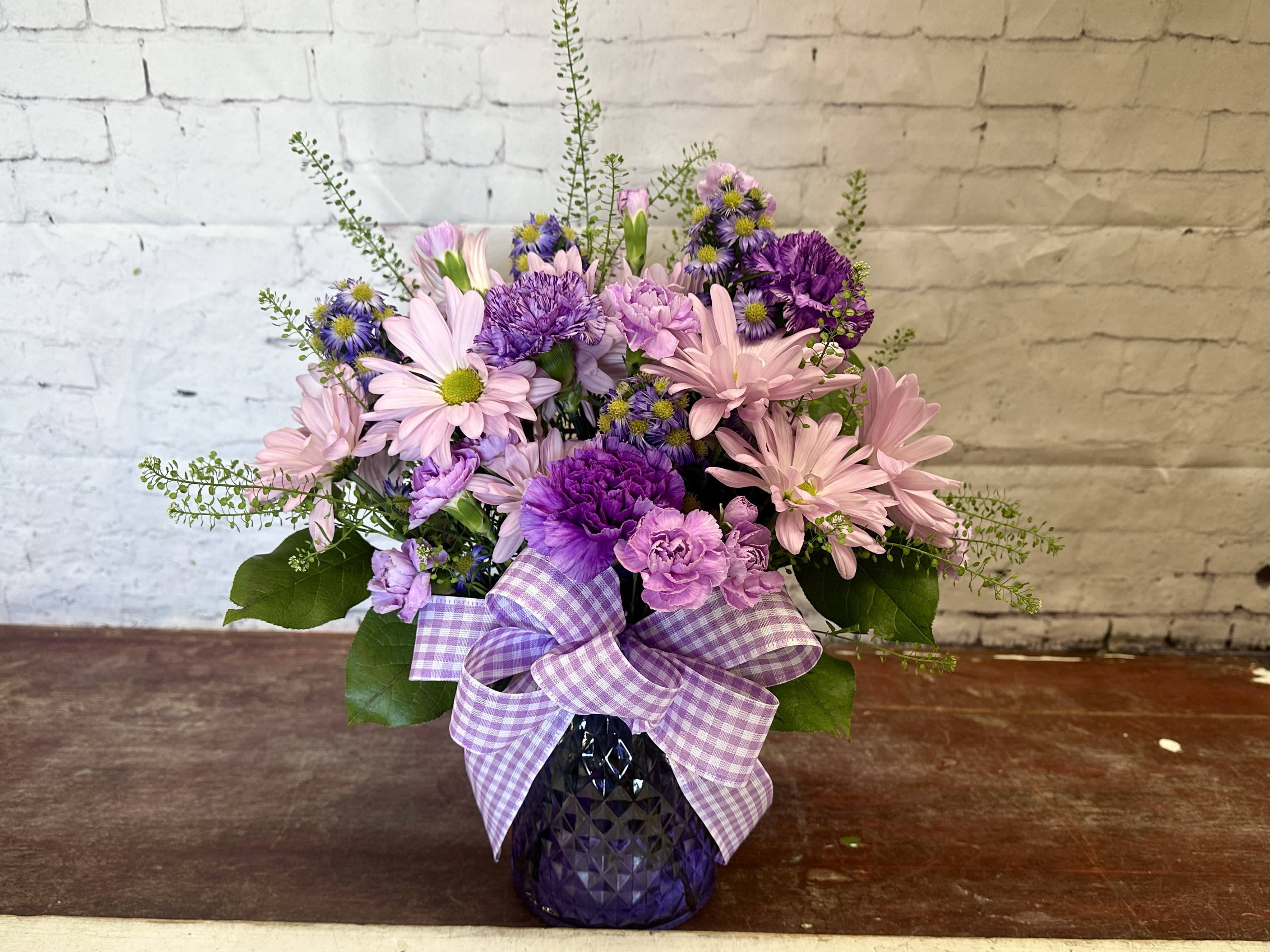 Violet whisper  - Mix of purple and lavender blooms in purple glass vase 