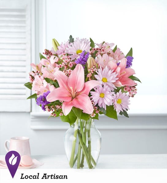 Pink and lavender mixed bouquet in a clear glass vase