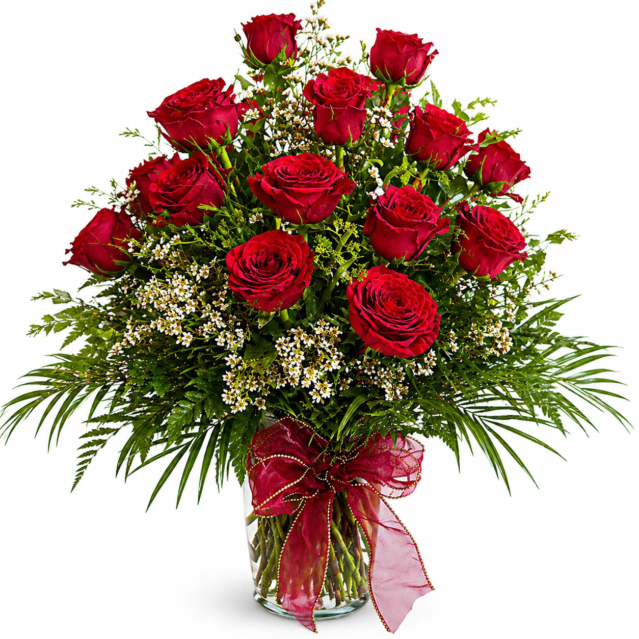 The Elizabetha (10% off Mother's Day Special) - A clustered tower of deep red roses rises above a cloud of tiny white filler and lush greenery, creating a classic romantic bouquet perfect for Mother's Day, an anniversary, Valentine's Day, or any love-focused celebration. The saturated red-and-green contrast and upright, formal silhouette give the person you're thinking of an immediate sense of being cherished-this is the kind of arrangement that reads as devotion the moment it arrives.  The design is full and rounded with strong vertical height: multiple long-stem red roses densely packed into a tall display, interspersed with fine white blossoms and palm-like fronds that extend outward for a dramatic profile. Presented in a clear glass vase and finished with a red (or burgundy) ribbon, the arrangement feels dressed up and gift-ready. Its size and lush layering make it a statement piece-choose it when you want her to feel truly celebrated. Care: keep the vase filled with fresh water and trim stems every few days to prolong bloom life.