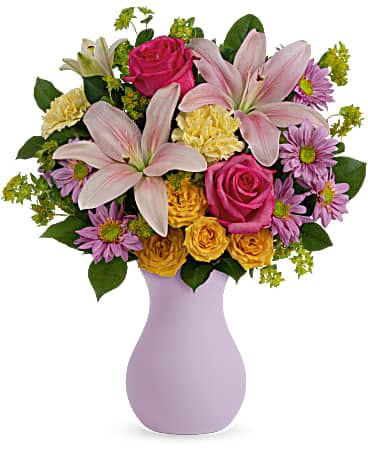 Pink roses and lilies in a lavender vase