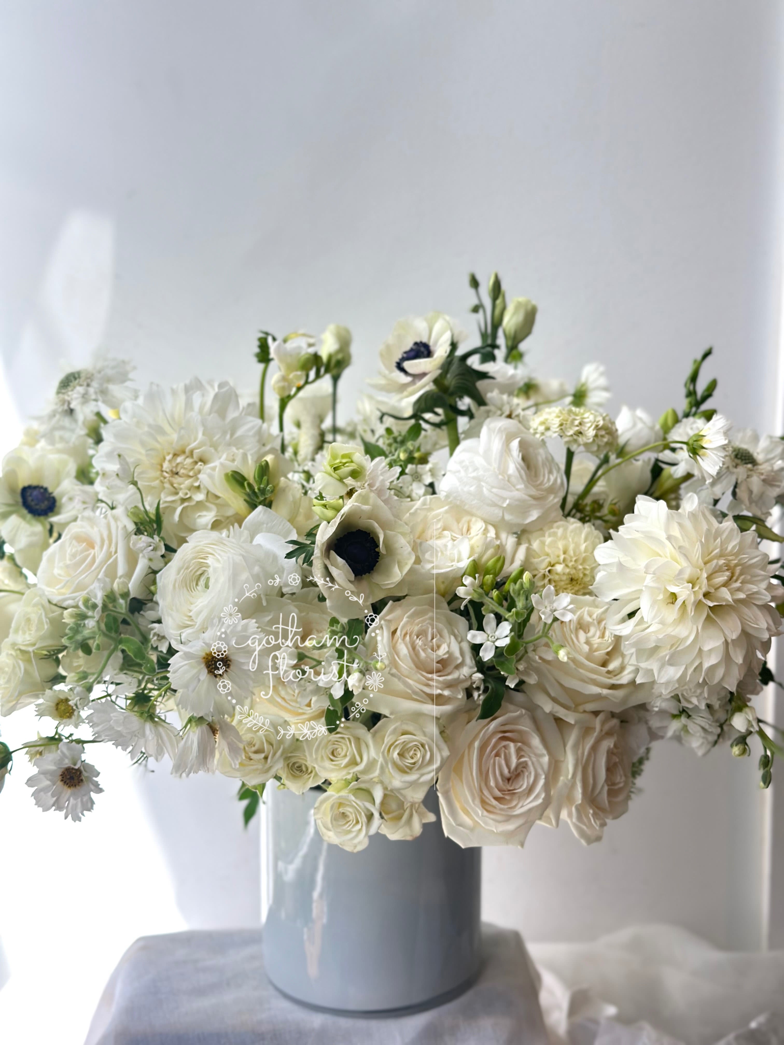 White floral arrangement in a blue vase