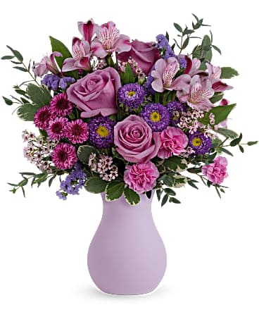 Pink and purple mixed bouquet in a lavender vase