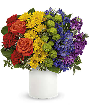 Colorful mixed bouquet in a white vase with roses and daisies
