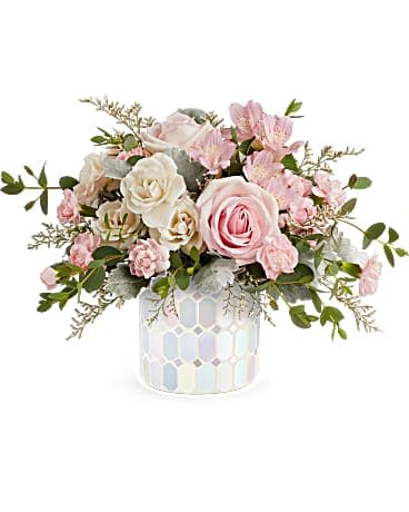 Pink and white rose arrangement in a patterned vase