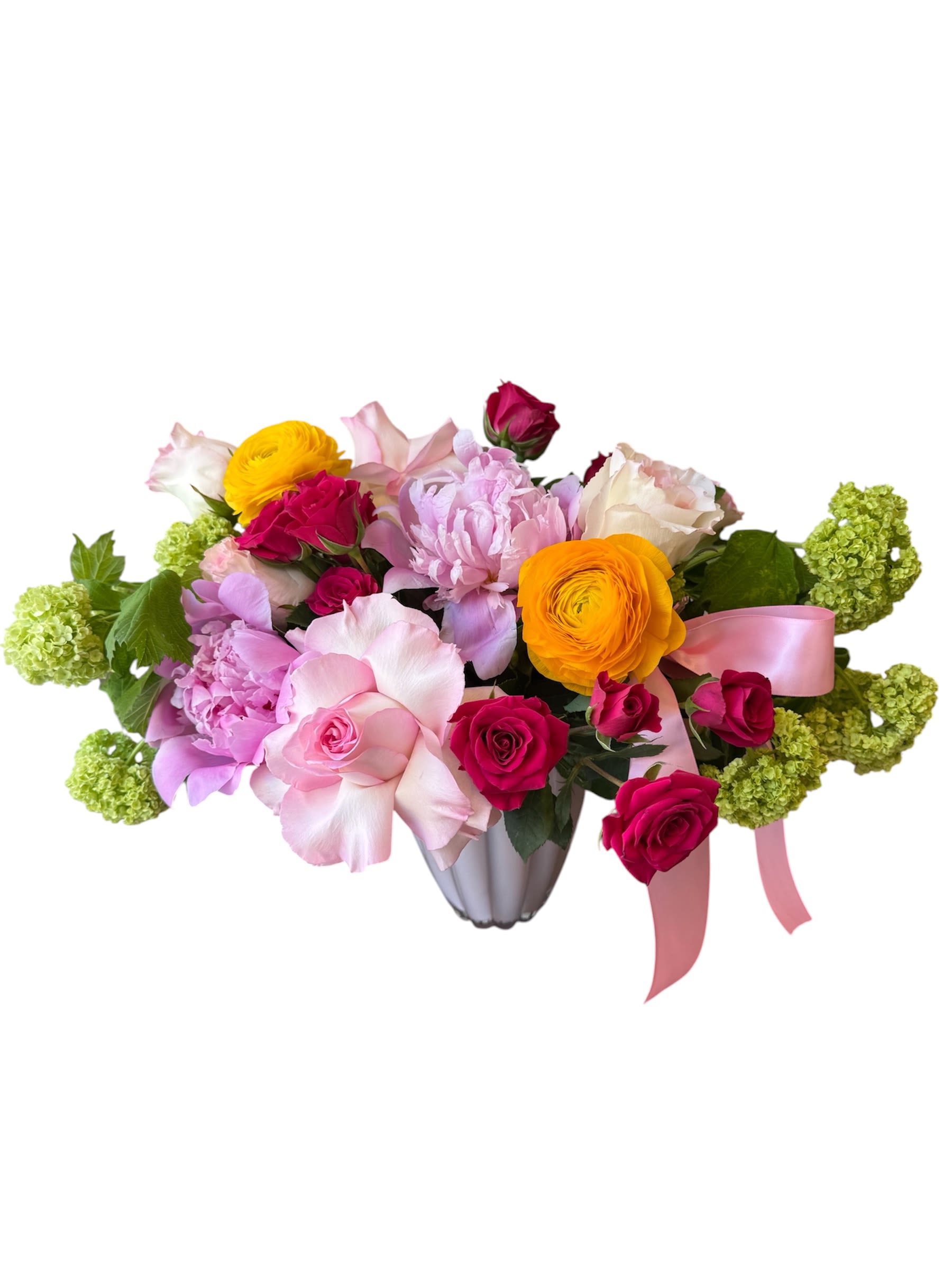 For All You Do - Pink roses, pink peonies, hot pink spray roses, yellow ranunculus and viburnum designed in a glass vase with a pink ribbon. As shown in the photo.