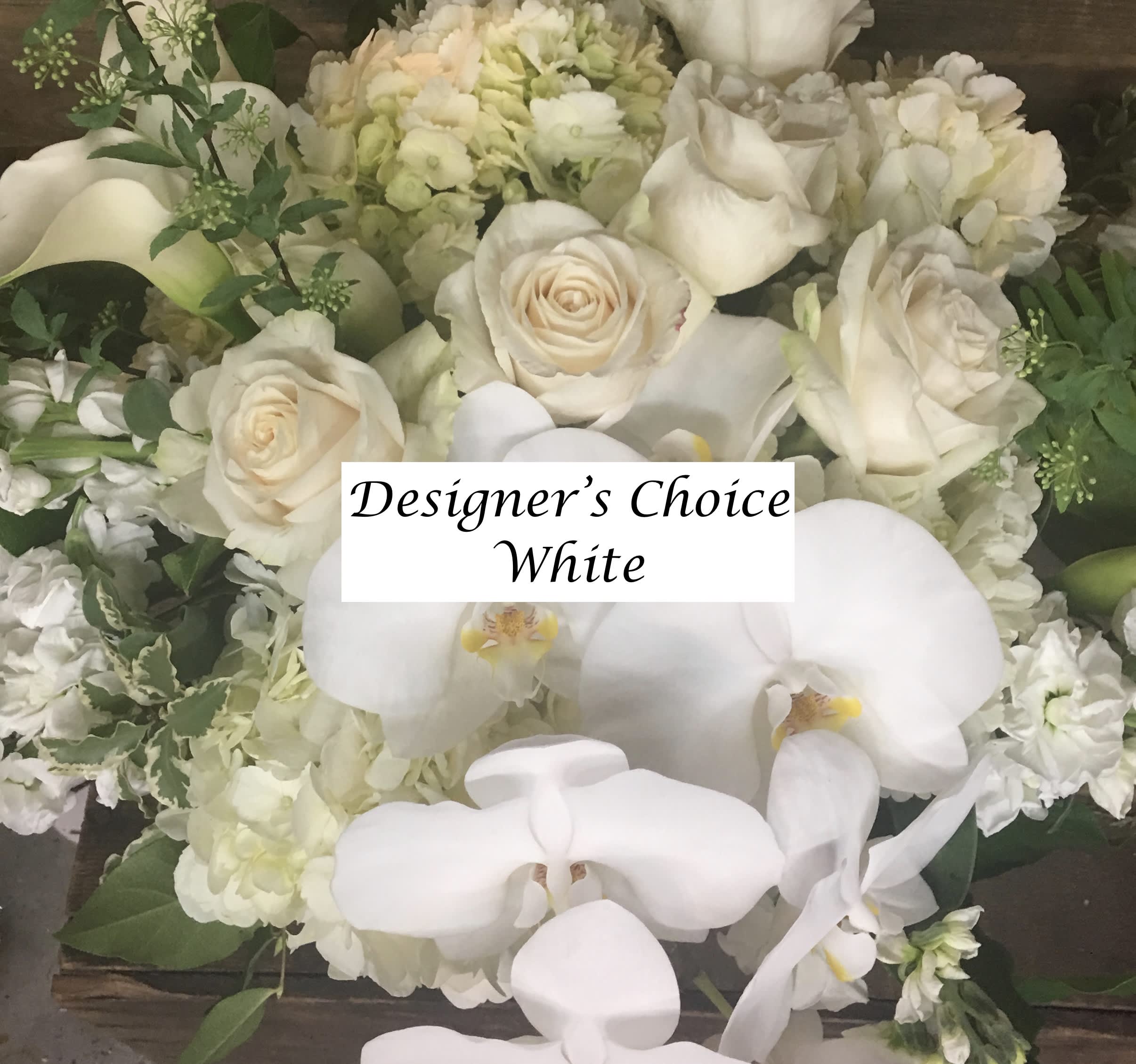 White roses and orchids in a dense floral arrangement