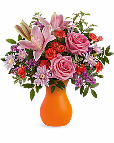Pink lilies and roses in an orange vase