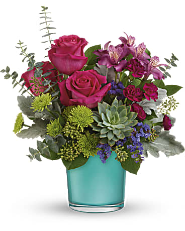 Pink roses and purple flowers in a turquoise glass vase