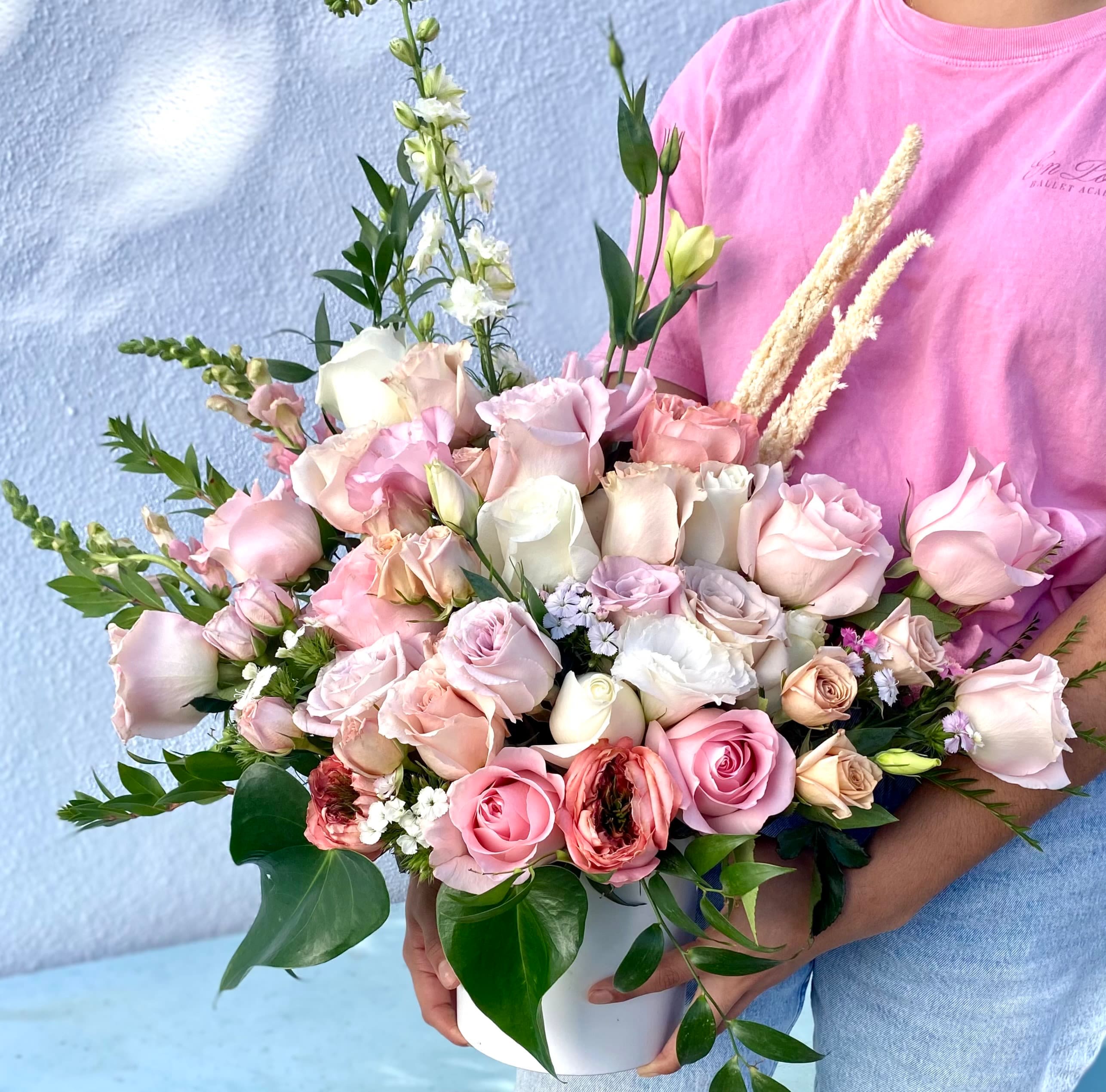 Lush Roses - Soft color roses arranged in white ceramic vase.