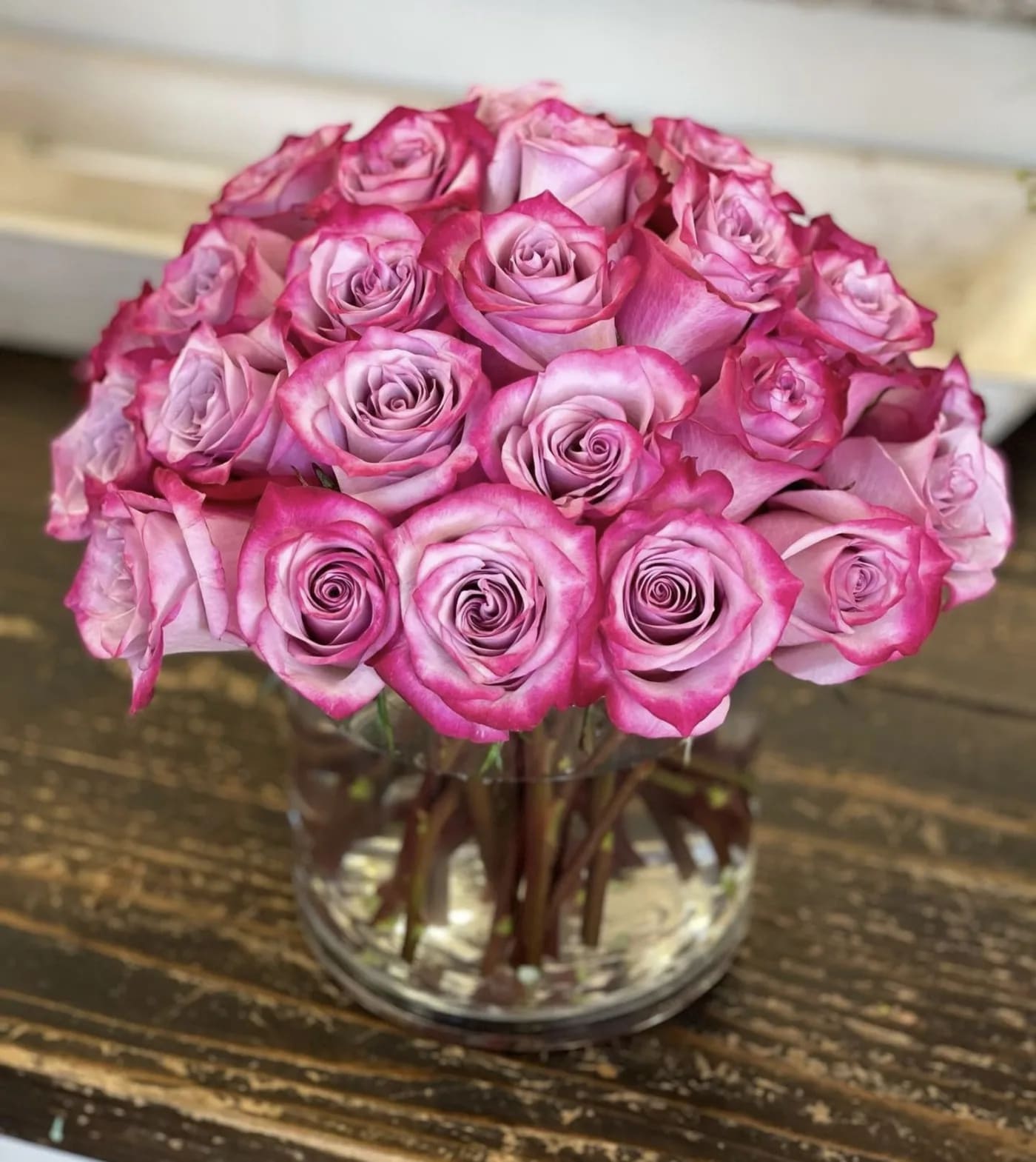Pink roses arranged in a clear glass vase