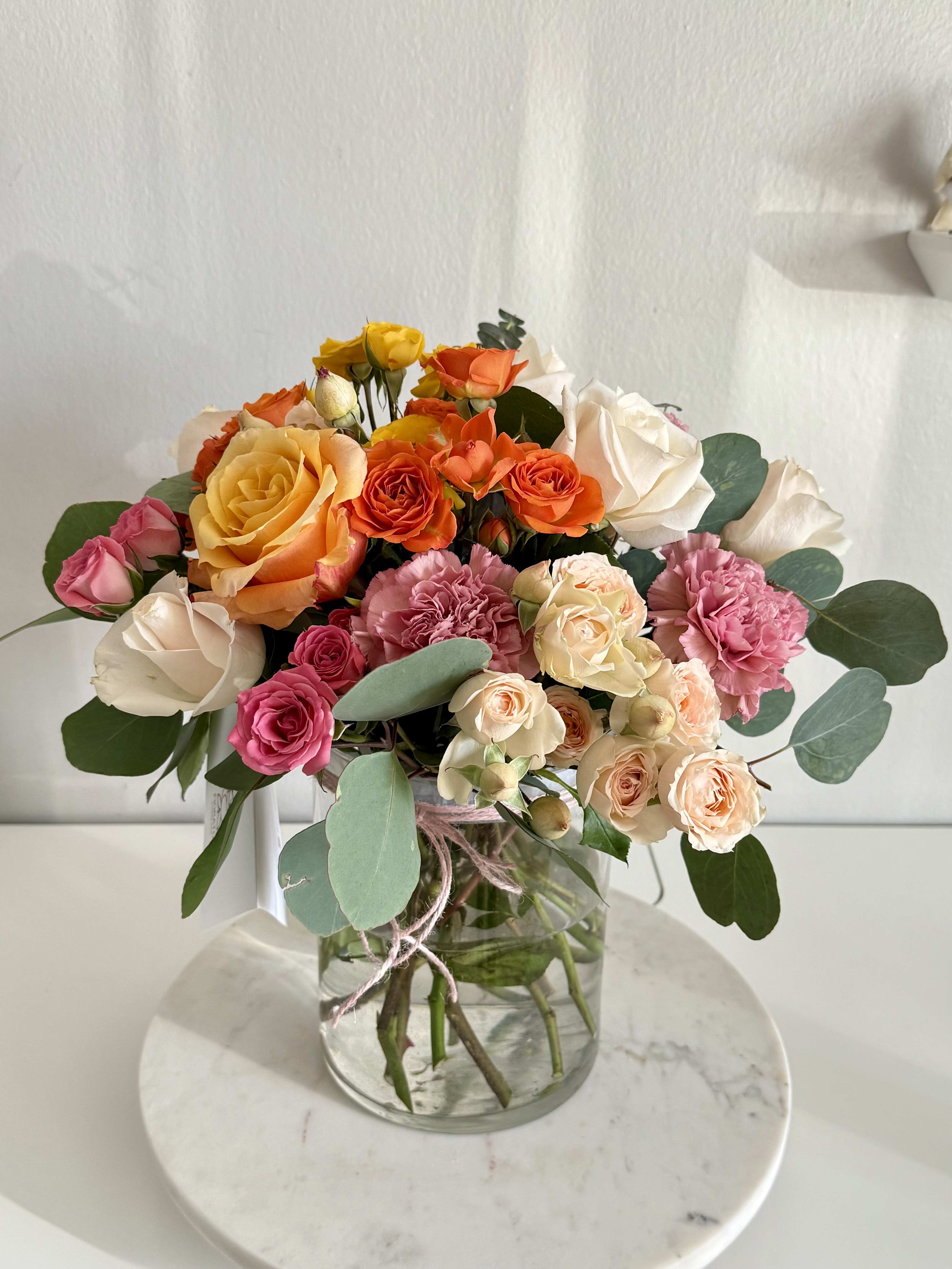 Mixed roses and carnations in a glass vase