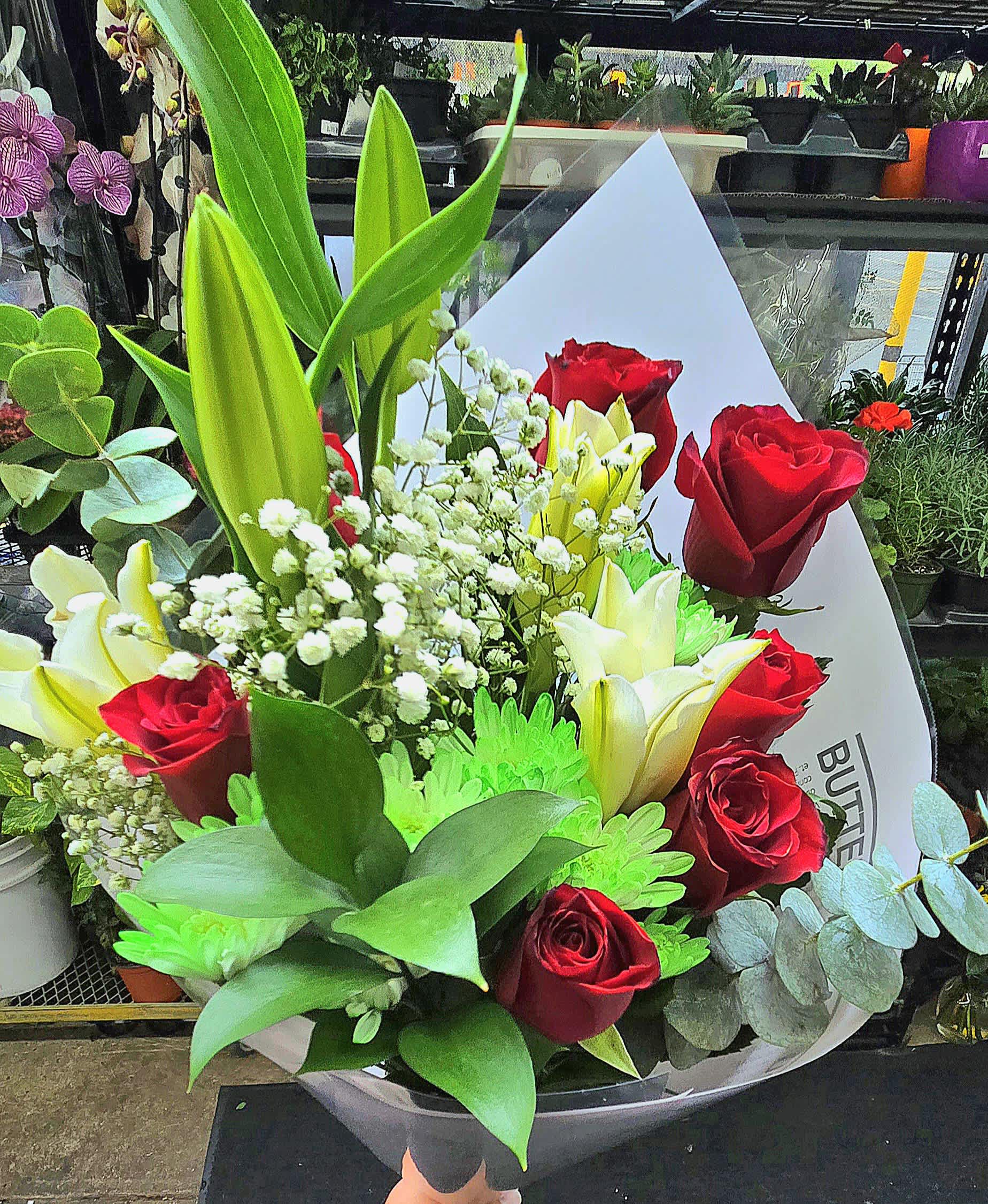 Bouquet of red roses and white lilies with baby's breath