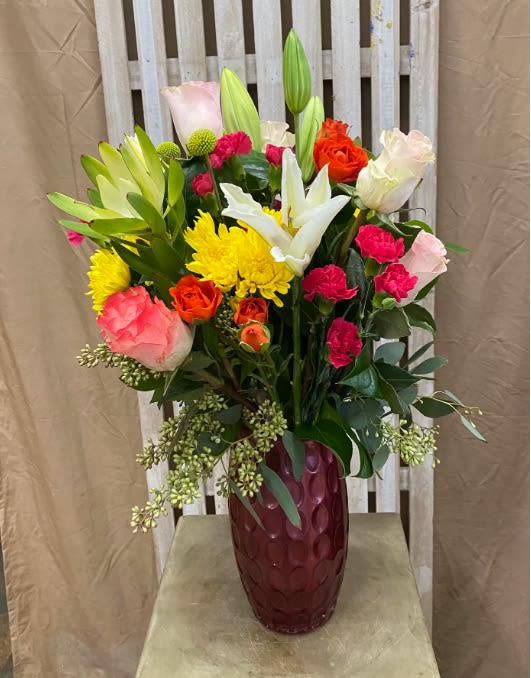California Sunset - Soft, glowing, and effortlessly romantic, California Sunset blends warm sunset tones with fresh whites for a look that feels both vibrant and serene. Creamy white lilies bring an airy elegance, while pops of hot pink and sunset-inspired hues add warmth and depth. Lush greenery completes the design, creating a balanced arrangement that feels perfect for celebrations, anniversaries, thank-you gifts, or simply bringing a little golden-hour beauty indoors. This piece captures the feeling of a peaceful evening by the shore—refined, joyful, and timeless.