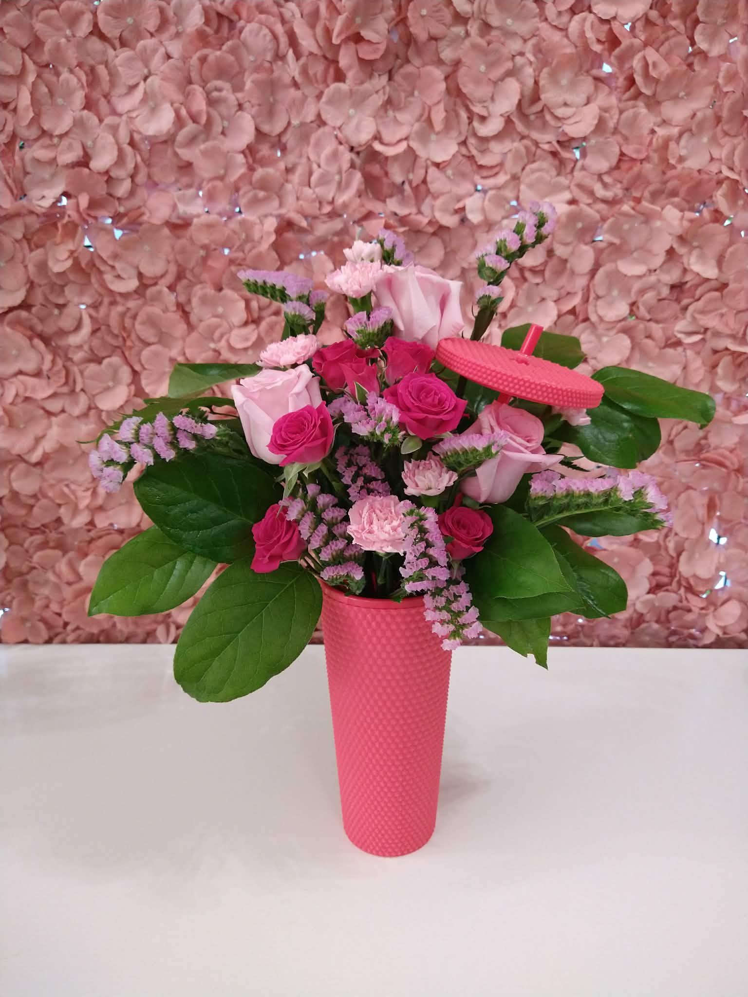 Mother's Day Studded Tumbler - An assortment of pink florals in a studded tumbler with a lid and straw.