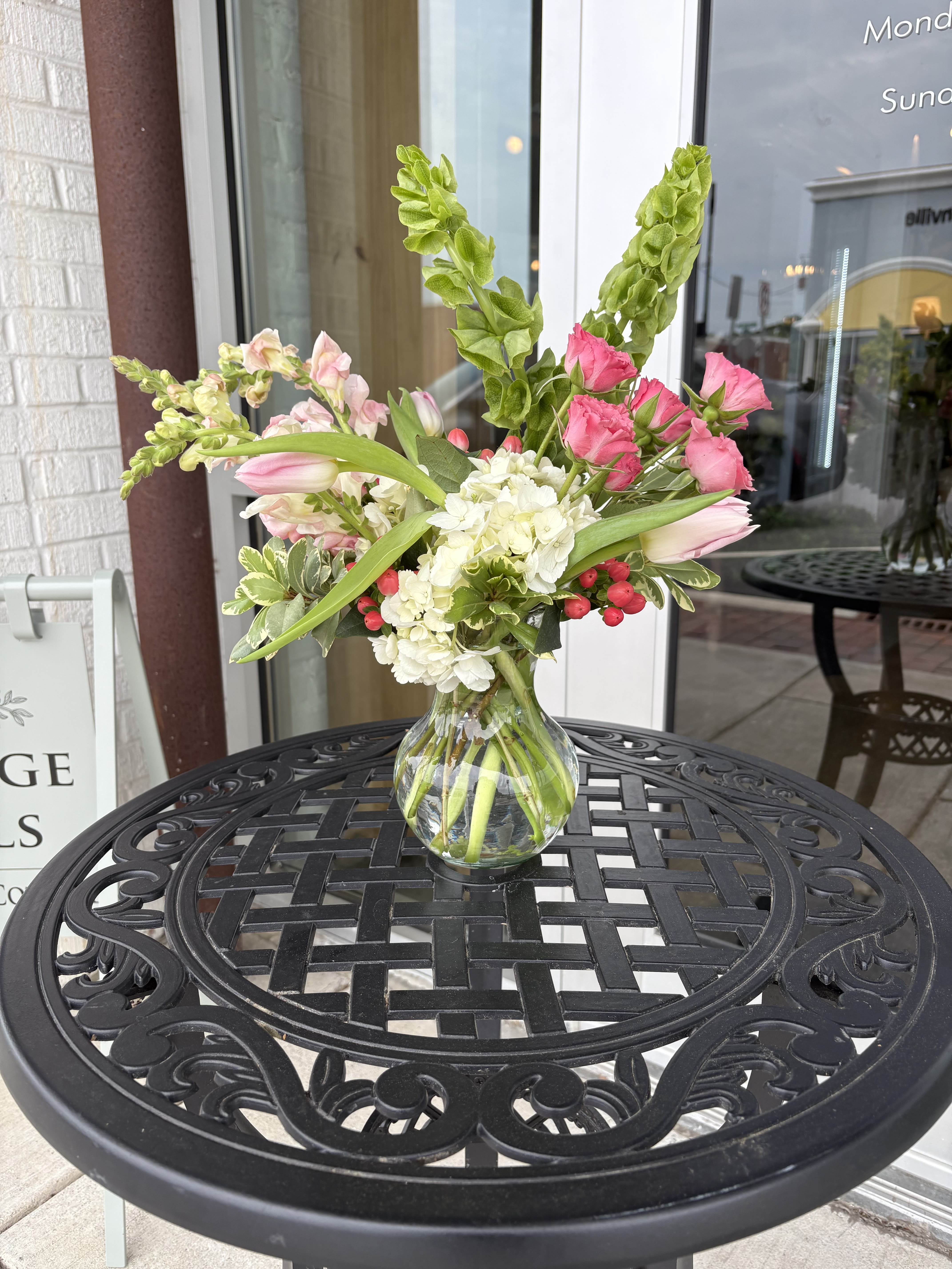 Mothers Day Signature Garden - Celebrate Mom with a beautifully designed arrangement created to brighten her day and show just how much she means to you. Our Mother’s Day arrangement features a fresh mix of seasonal blooms, thoughtfully styled in our signature garden-inspired design. Soft textures, vibrant colors, and hand-selected flowers come together to create something truly special—perfect for honoring the love, strength, and beauty of every mom.    Flower color choices are not guaranteed, but the overall style and design are guaranteed. 
