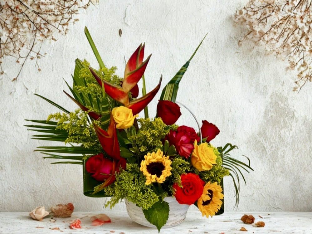 Tropical Torch - This high style arrangement blends the exotic flair with the warmth of sunflowers and red roses accented with fan like palms and delicate green fillers