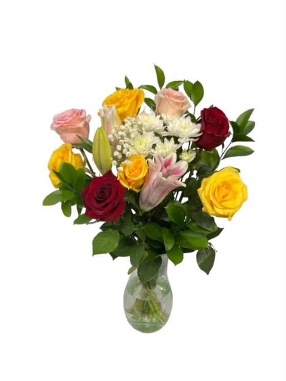 Mixed roses and lilies arranged in a clear glass vase