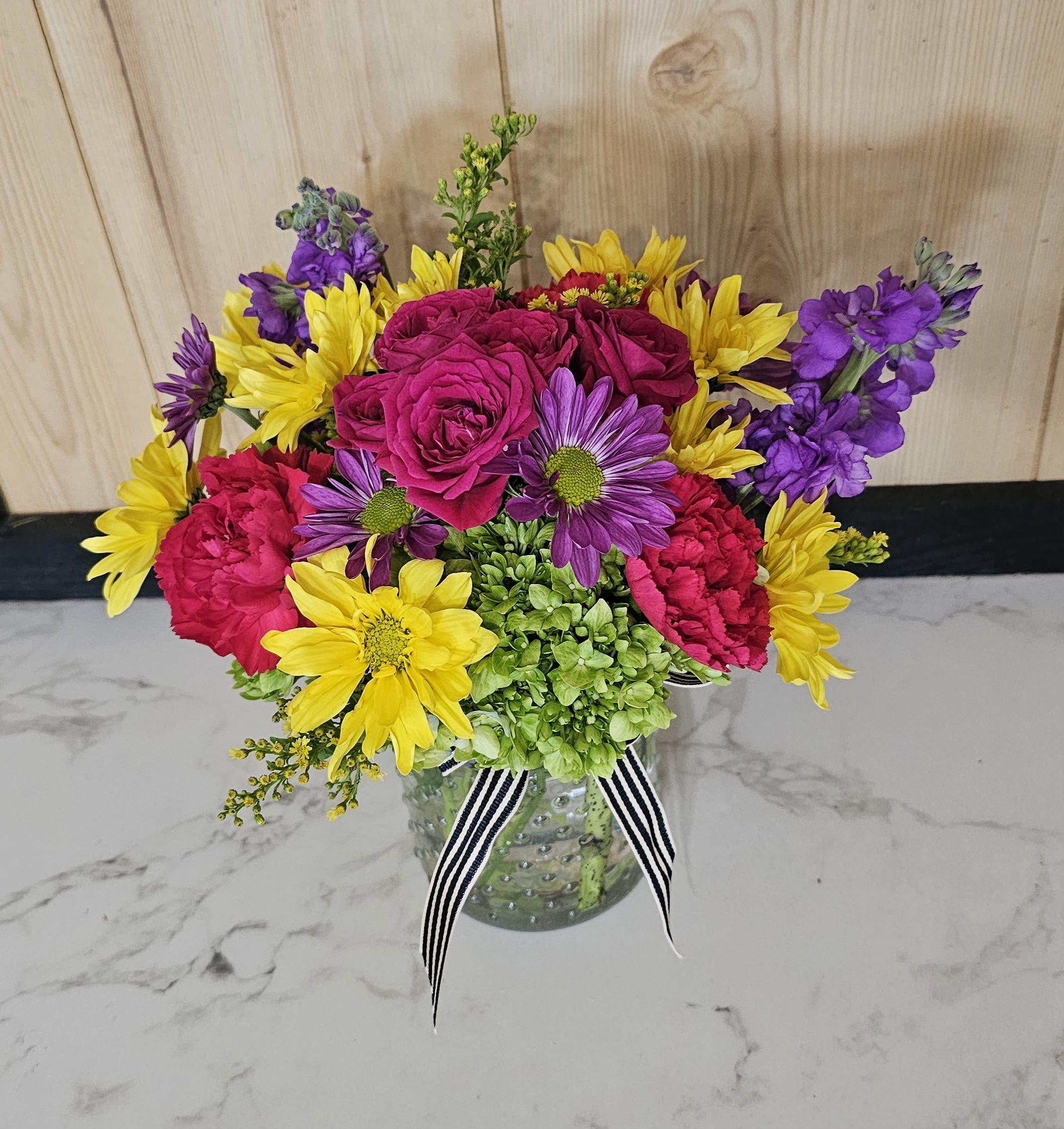 Mother's Love - A bright colorful arrangement in a jar style vase.