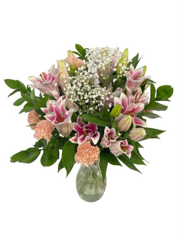 Pink lilies and carnations in a glass vase