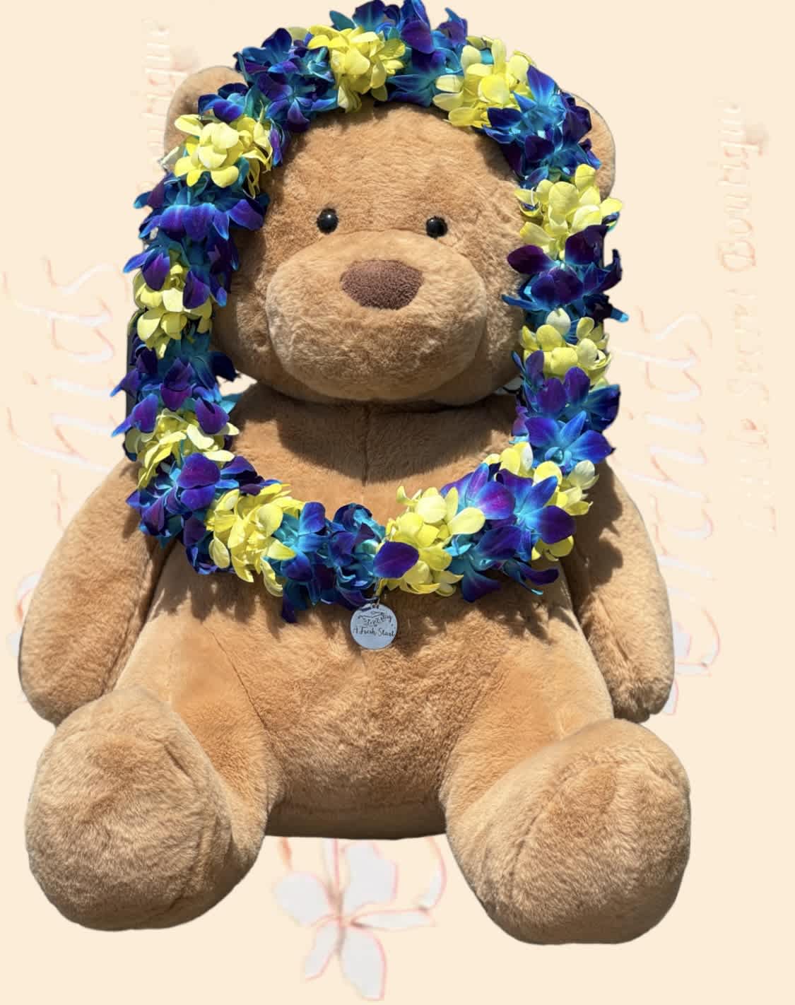 Teddy bear wearing a blue, purple, and yellow flower lei