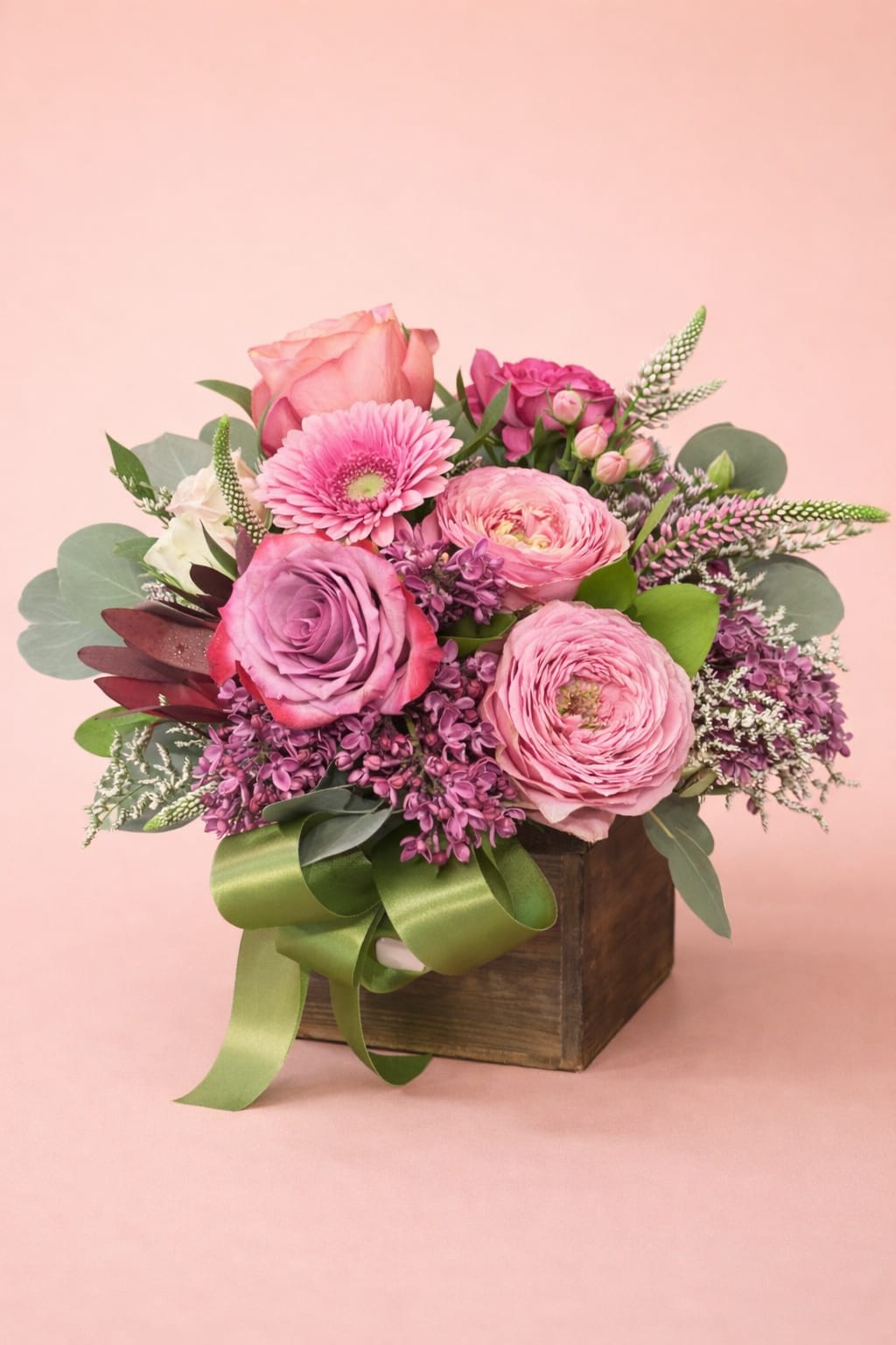 Blushing Lavender Garden Box – Designer’s Choice | Mother’s Day Special - Our Blushing Lavender Garden Box features a romantic mix of soft pinks, mauves, and lavender tones for a fuller, more elevated take on classic pink arrangements.  Designed as a Designer’s Choice piece, each arrangement will be created with premium fresh florals in this color palette, keeping the same size and overall feel while allowing our designers to select the best blooms available.  Set in a rustic wooden box, this arrangement feels both modern and timeless, and is a great option when you want something a little more unique than traditional all-pink.   Color palette: Pink, mauve, lavender  Style: Lush, romantic, slightly elevated  Price point: Special value design (~$75)  Best for: “She loves pink—but make it a little different”