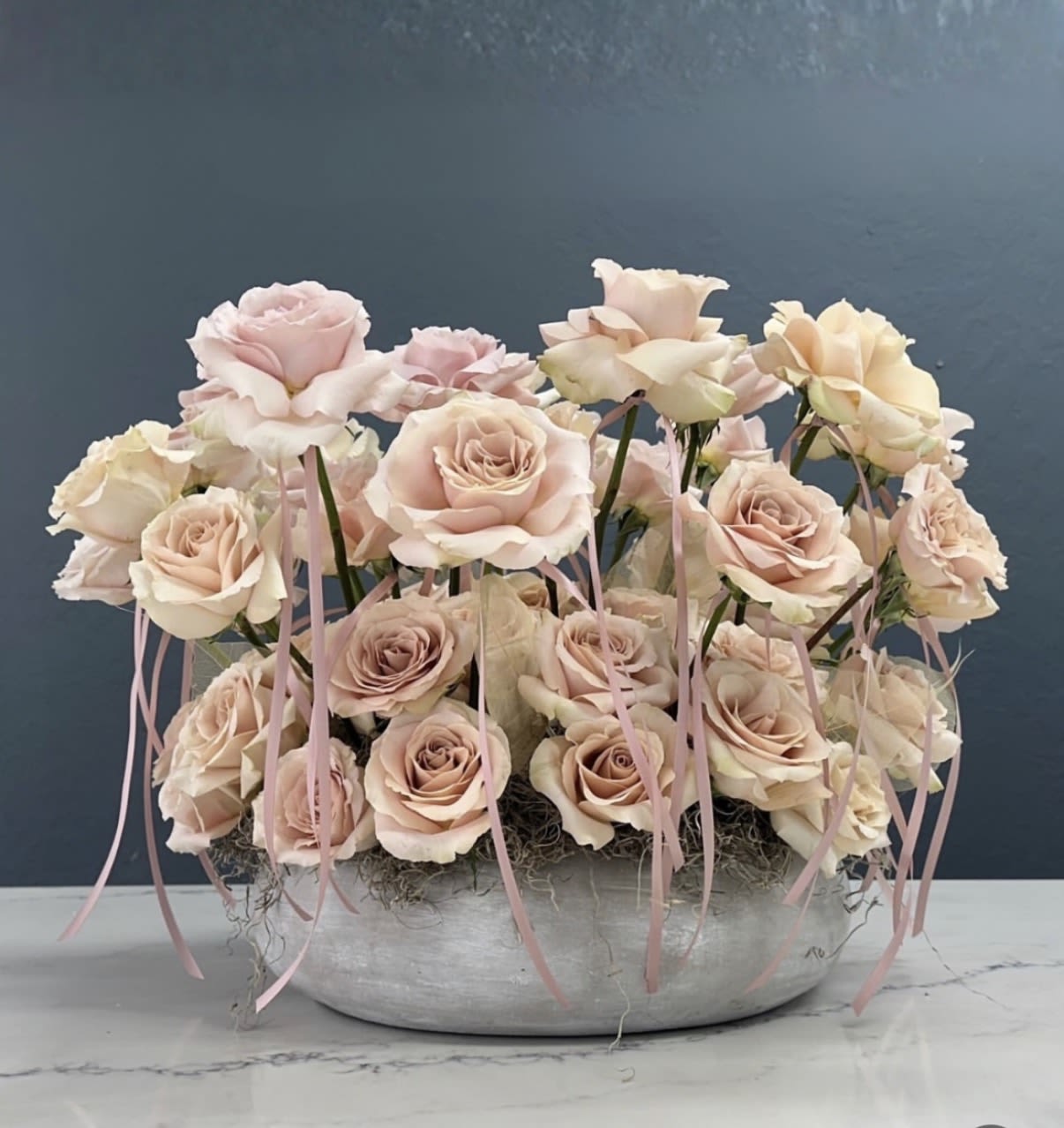 Roses Carusel - A beautiful gathered 360 carusel of quick sand or red roses, growing out of a cement circular vase.
