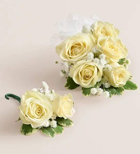 Cream rose corsage and boutonniere with white filler flowers