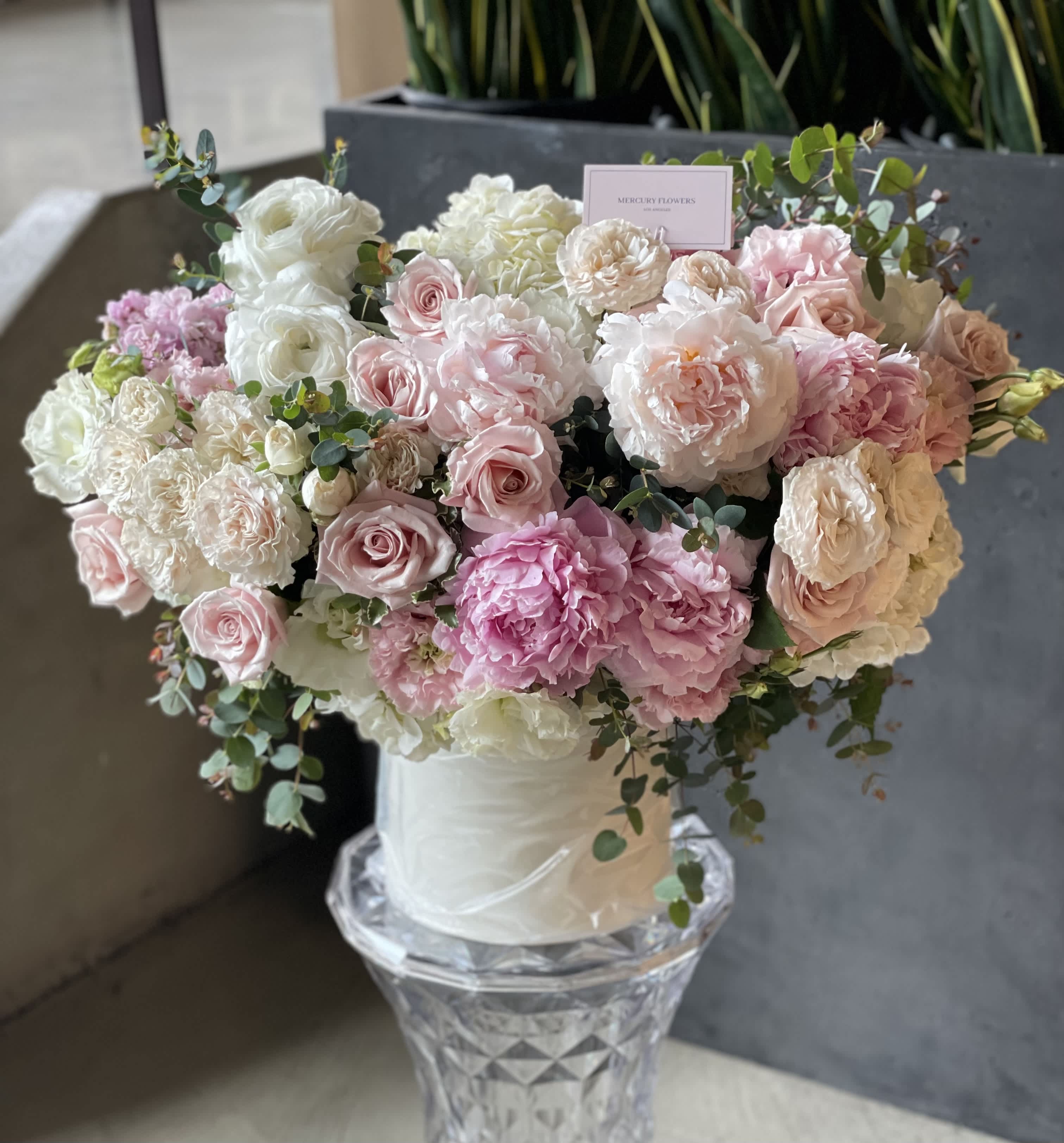 Pink and white rose bouquet in a clear vase