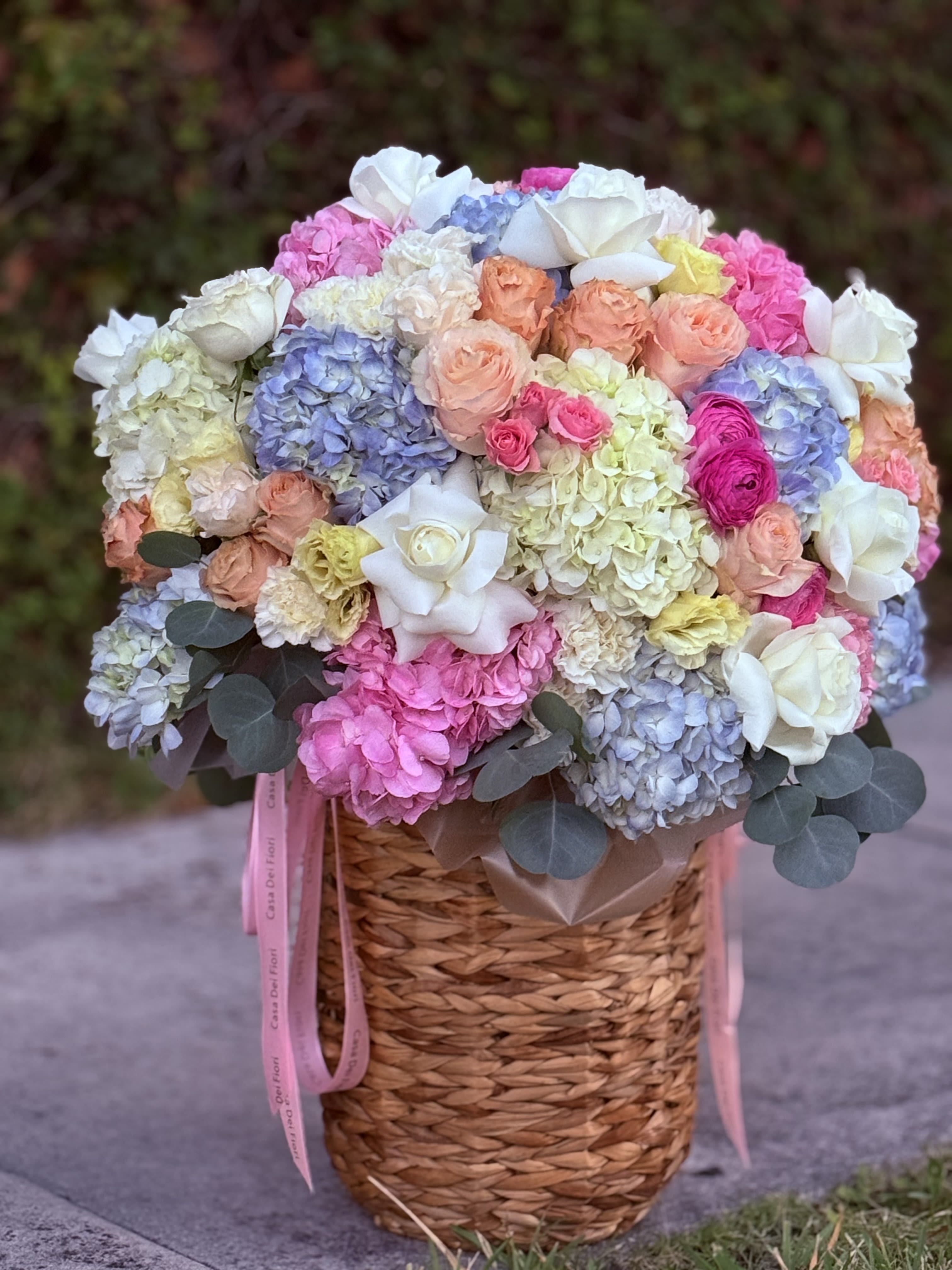 Garden Grace - A beautifully designed garden-style arrangement featuring a soft blend of seasonal blooms arranged in an elegant basket. With its natural flow and delicate color palette, Garden Grace brings a sense of warmth, charm, and refined simplicity to any occasion.