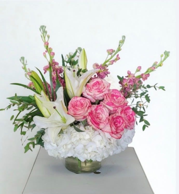 Blushing Charm  - This beautiful arrangement in a vase has pink roses, white hydrangeas, lilies, stock, greenery excellent choice for mother's day 