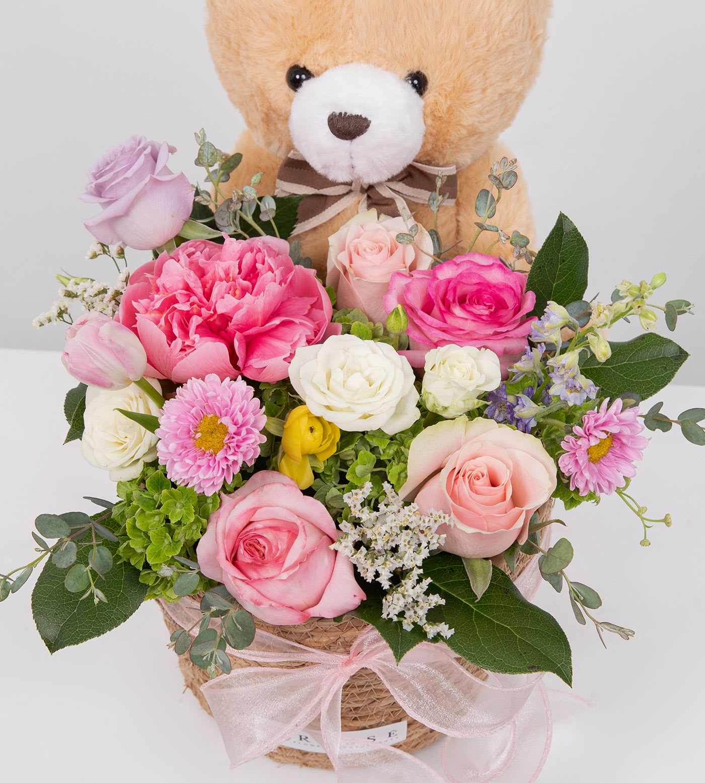 Sweet Garden Hug - A soft mix of pink and white blooms with a cuddly teddy bear—simple, sweet, and perfect for making Mom smile.