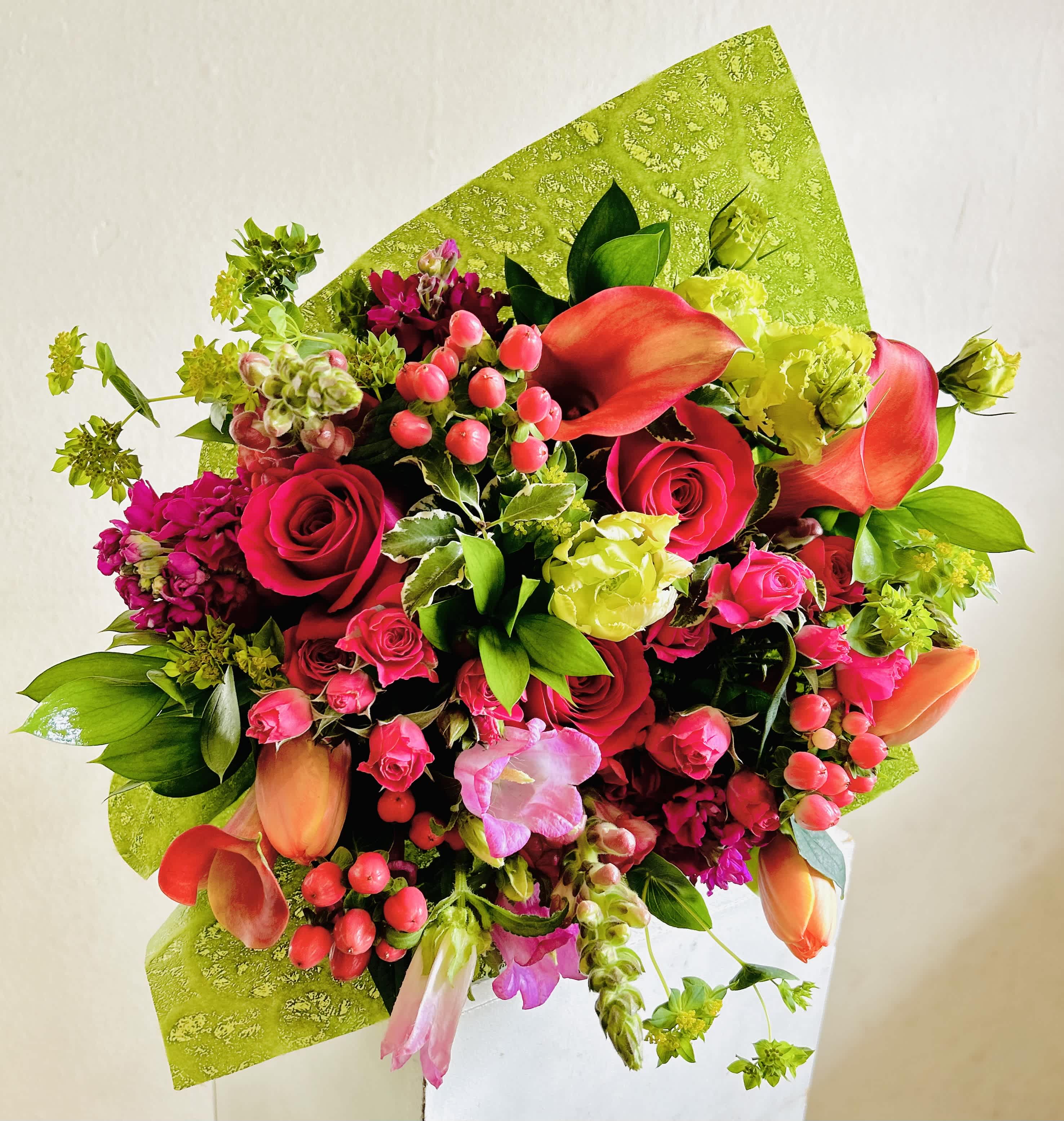 Bright mixed bouquet with red roses and orange calla lilies