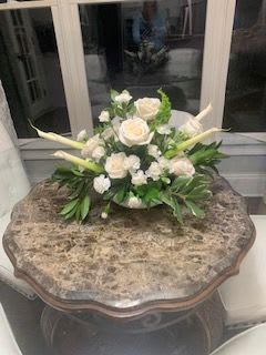 Ten Centerpieces in White - Client provides Florist with vases- Petals &amp; Blooms Flowers will recreate 10 table centerpieces in all white using roses, carnations, lisianthus and stock flowers based on clients inspirational photos. 