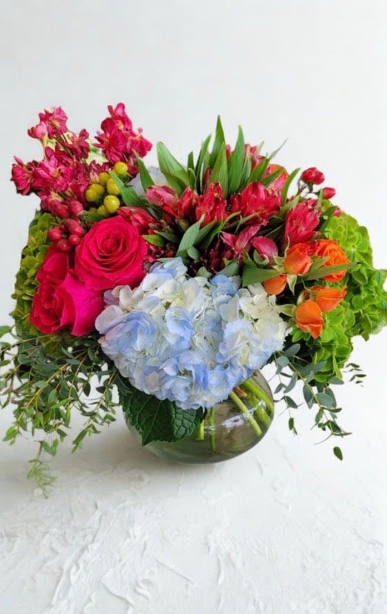 Blushing Elegance  - This is a vibrant arrangement in a vase with hydrangeas, roses, alstroemeria, hypericum and variety of greener