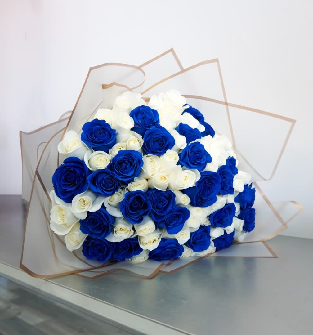 Bouquet of blue and white roses wrapped in clear paper