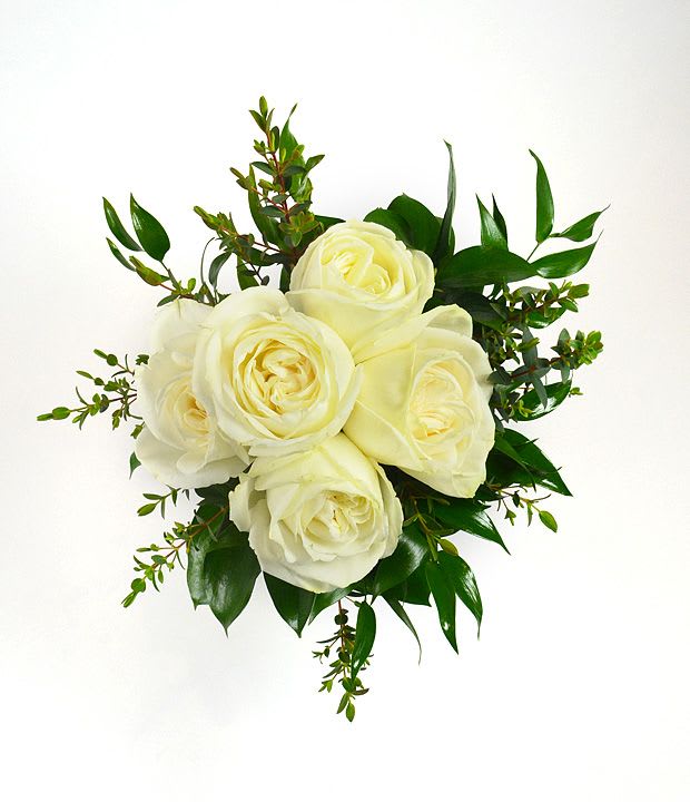 Pure Grace Prom Bouquet - A timeless petite prom bouquet, featuring pristine white roses surrounded by lush greenery. Effortlessly elegant and beautifully simple, this bouquet embodies purity and grace, making it the perfect complement to any enchanting evening. 